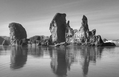 Panoramic view of rock formation in sea against sky