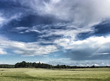 Scenic view of landscape against cloudy sky