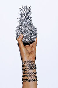 Hand in bracelets and silver pineapple. minimal fashion accessories