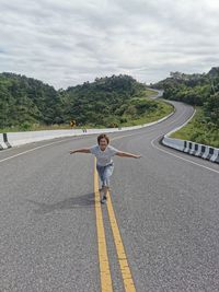 Portrait of woman standing on road