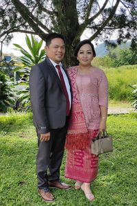 Portrait of young couple standing on field