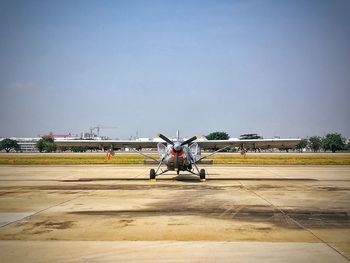 Airplane on airport runway against clear sky