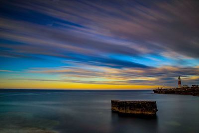 Scenic view of sea against sky at sunset