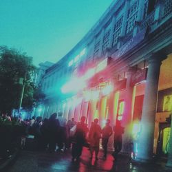 People on illuminated city at night