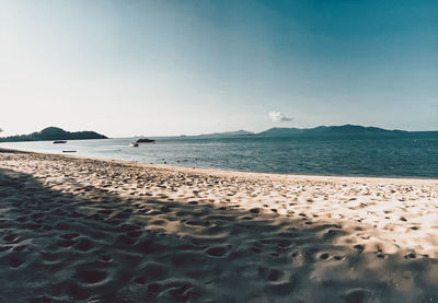 Scenic view of beach against clear sky