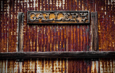 Close-up of gallery text on old wall