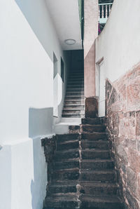 Low angle view of steps amidst buildings