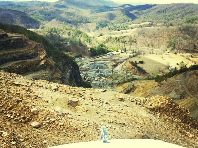 mountain, leisure activity, high angle view, lifestyles, landscape, nature, tranquility, tranquil scene, scenics, beauty in nature, men, mountain range, water, non-urban scene, rock - object, unrecognizable person, day, sunlight