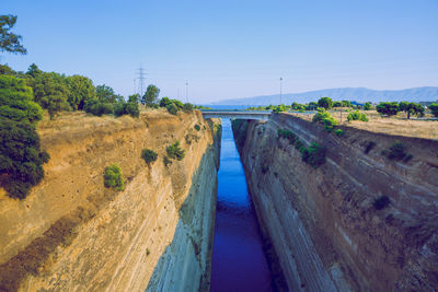 Panoramic shot of road by river against clear sky