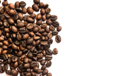 Close-up of coffee beans against white background