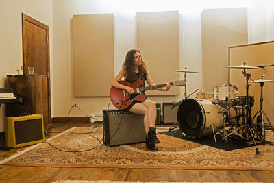 Young woman playing an electric guitar