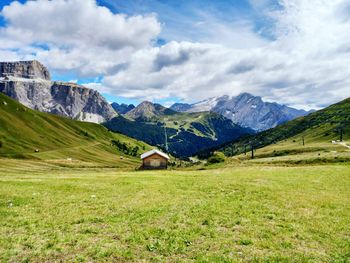 Scenic view of field and mountains against sky