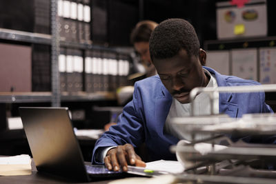 Side view of man working at office