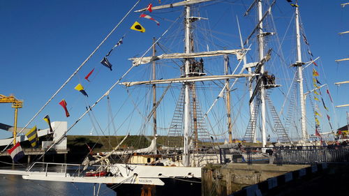 Low angle view of harbor against clear blue sky