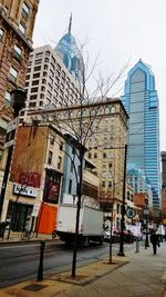 City street and buildings against sky