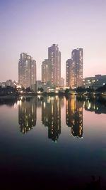 Reflection of illuminated buildings in city at night