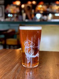 Close-up of beer glass on table