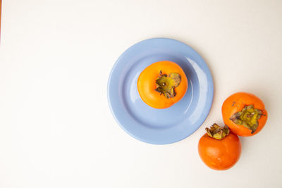 High angle view of orange slices in bowl against white background