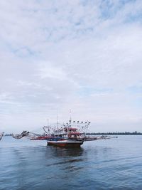 Boats in sea against sky