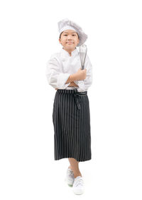 Portrait of cute girl standing against white background