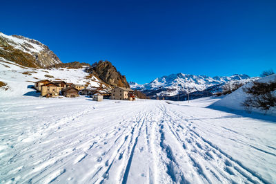 View of the village of grevasalvas, and lake sils, in engadine, switzerland, in winter.