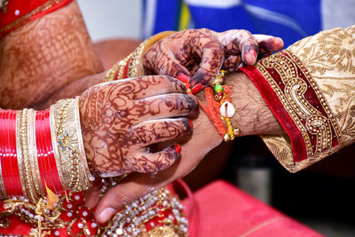 Midsection of couple holding hands