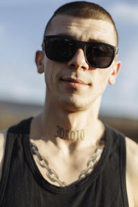 Close-up portrait of smiling young man with sunglasses