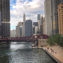 View of bridge over river with buildings in background