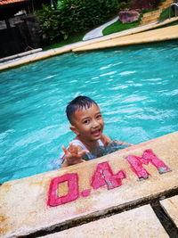 Portrait of smiling boy in swimming pool