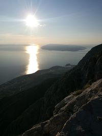 Scenic view of sea and mountains against sky