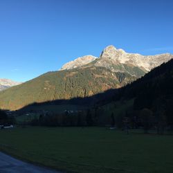 Scenic view of mountains against blue sky