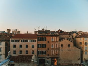 Buildings in city against blue sky