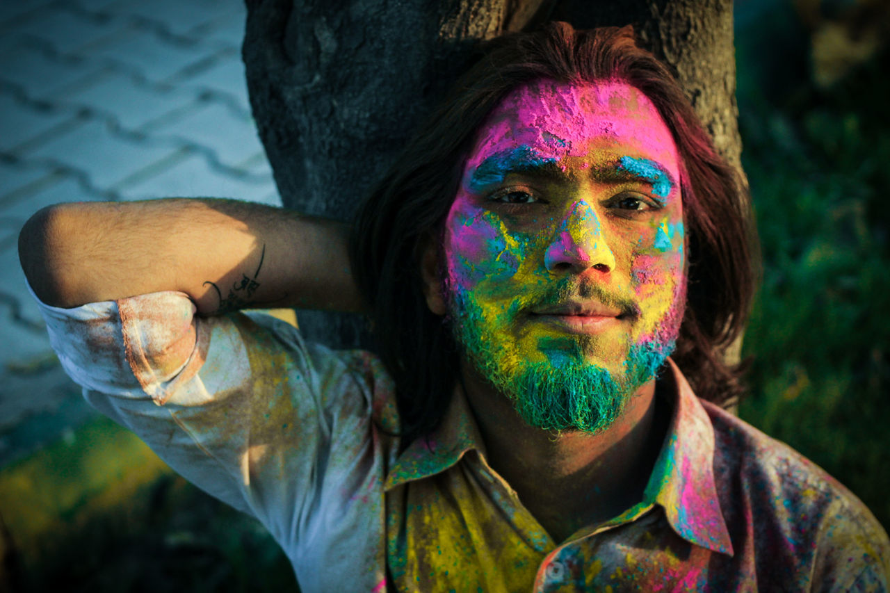 multi colored, portrait, holi, one person, celebration, traditional festival, headshot, paint, real people, smiling, happiness, focus on foreground, front view, powder paint, face paint, human face, body paint, festival, teenager, hairstyle