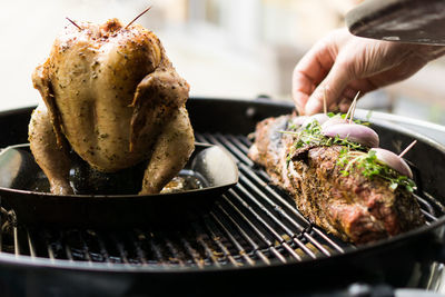 Cropped hand on meat