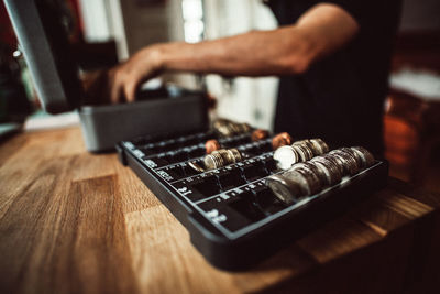 Close-up of man counting coins