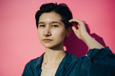 Portrait of young man against red background