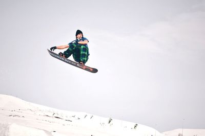 Full length of man paragliding against sky during winter