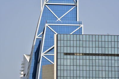 Low angle view of modern building against clear blue sky