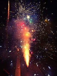 Low angle view of firework display at night