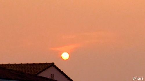 Low angle view of built structure at sunset