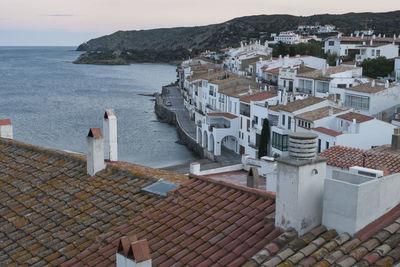 High angle view of townscape by sea against sky