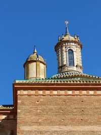 Low angle view of building against clear blue sky