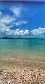 View of seascape against cloudy sky