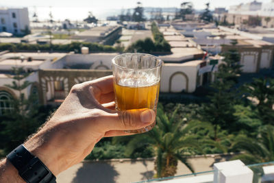 Midsection of woman holding beer glass