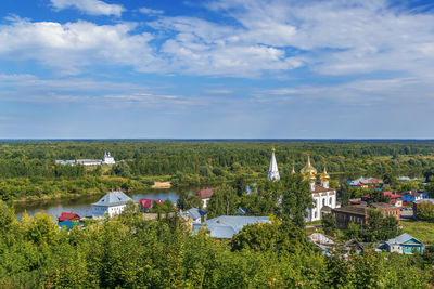 Scenic view of trees and buildings against sky