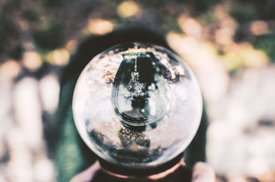 Close-up of hand holding crystal ball