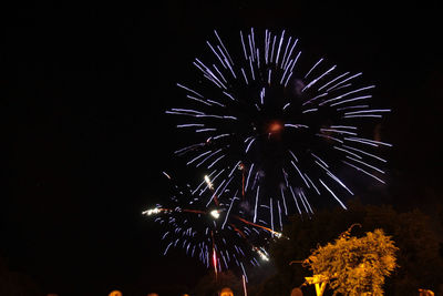 Low angle view of firework display at night