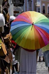 A person walking in the streets of pelourinho with a colorful umbrella. salvador, bahia, brazil