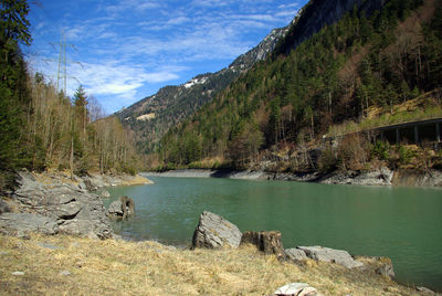 Scenic view of lake and mountains against sky