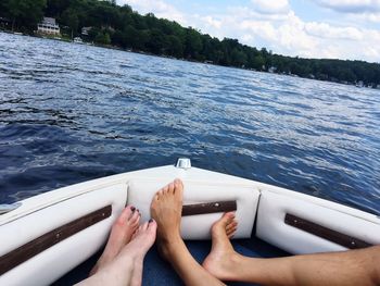 Low section of people on boat against sea